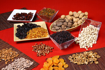 Different nuts and dried fruits in different and colorful pots