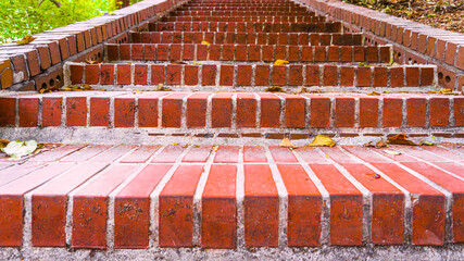 A uniform red brick staircase going up the mountain