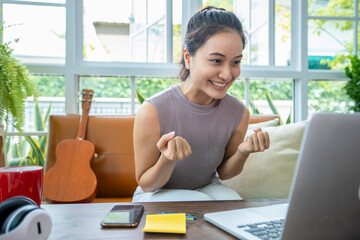 Asian  businesswomen Success and winning concept - happy and  raised up hands celebrating with laptop the breakthrough and achievements,startup small business concept