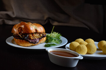 Kaiser roll with pastrami and stewed sauerkraut