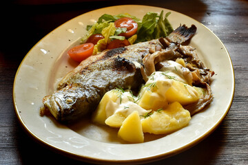 Grilled broiled trout with garnish potatoes