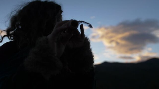 Woman Using a Robe, playing the Flute