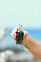 Hand held bottle, sample of the wartime rubbish on the shores of  Million Dollar Point,Vanuatu,...