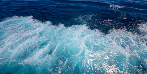 Top deck of Cruise Ship view wake and rough deep blue and turquoise pacific ocean with white foam texture background.