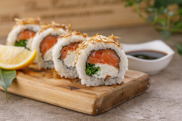 Sushi rolls with tuna shavings on a textured still life background. Restaurant concept. Close-up.
