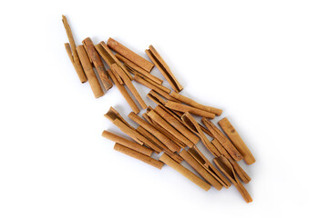 Heap of cinnamon sticks on white
