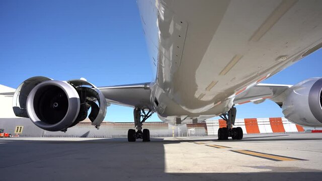 Jet engine of  a commercial plane being test run with the cowls open.