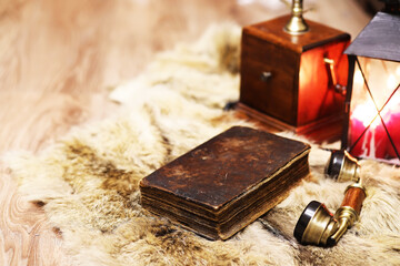 Retro old book and world desk globe on fur, learning and education concepts.