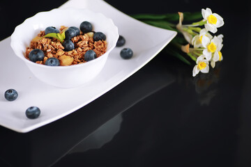 A healthy breakfast cereal with milk and fruit. Oat and corn flakes with chocolate and yogurt. The concept of healthy and vegetarian food.