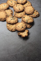 Many handmade chocolate cookies on a grey background
