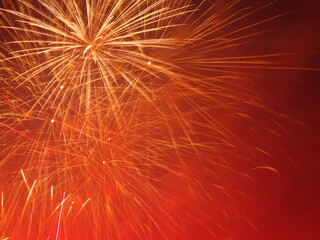 Orange and Red Fireworks on a Smokey Night Sky