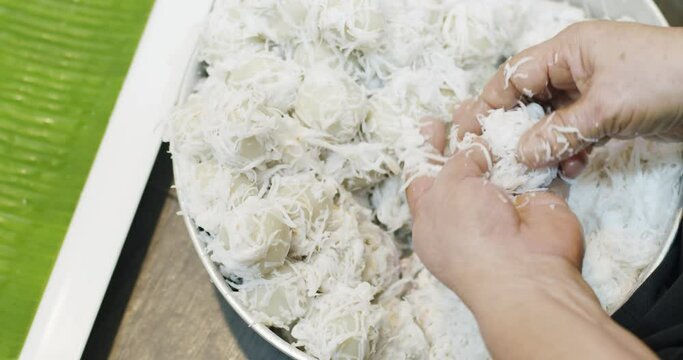 Close up chef hands cooking Coconut Balls or Ka Nom Tom, Thai Traditional Dessert
