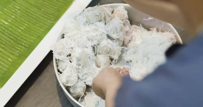 Close up chef hands cooking Coconut Balls or Ka Nom Tom, Thai Traditional Dessert