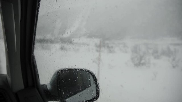Winter view from car mirror