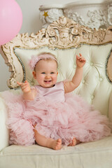 Obraz na płótnie Canvas Baby girl at pink dress