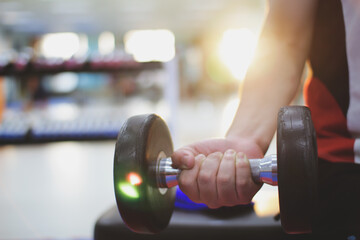  person exercising with dumbbells workout in gym,pumping up muscules with dumbbells