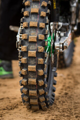 Close-up of parts of motocross bike. Tyre wheel close-up. Selective focus.