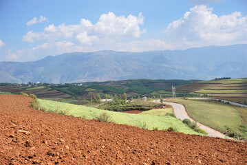 Dongchuan Red Earth Multi-Colored Terraces - Red Soil, Green Grass, Layered Terraces .