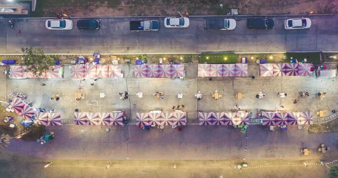 Food fair, festive food, street food or flea market in aerial view. Many people, booth tent, shop and vendor. Festival in resort mall, Tha Sala sub district, Amphur Donjan, Chiang Mai, Thailand.