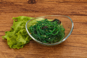 Green Chuka Seaweed Salad Isolated on White Background Top View. Wakame Sea Kelp Salat