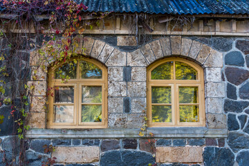 Fototapeta na wymiar Ancient Windows in an old Stone Building in Autumn