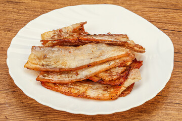 Roasted juicy bacon in the plate