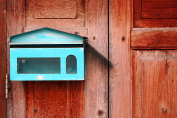 Vintage style - Blue mailbox with brown wooden door background - Send Receive mail message 