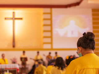People go to church for Sunday prayers.people wearing masks, praying, and standing apart,new...