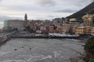 men canoeing in Nervi on a winter cloudy day, Genova, Liguria, Italy