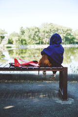 Sad kid sitting alone with dog and toy airplane on bench by the river bank. Diagnosing Early-Onset Childhood depression, autism