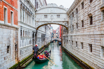 Gondolas floating on canal towards Bridge of Sighs (Ponte dei Sospiri). Venice, Italy © muratart
