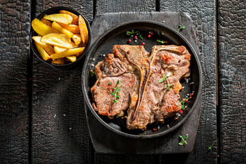 Well done tbone steak and chips with salt and herbs