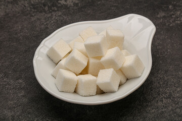 Refined white sugar cubs in the bowl