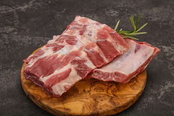 Raw pork ribs served rosemary