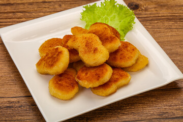 Fried chicken nuggets served salad leaves