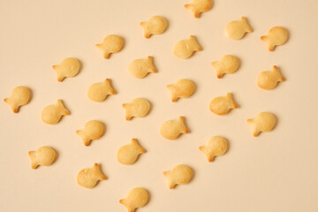 fish crackers on beige background top view