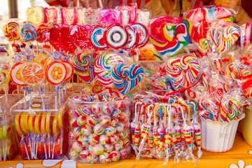 Selling colorful candies and sweets at the fair on stall, street market