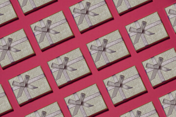 Silver gift box on a pink background.