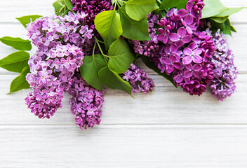 Lilac in flat style on white wooden background. Beautiful spring. Overhead view. Flat lay, top. Summer season. Natural spring style.