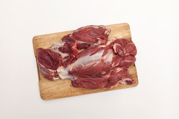 Fresh raw lamb meat on a wooden cutting board, top view, copy space