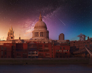 St Paul's cathedral and Millennium Bridge under starry night sky, London UK