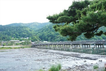 Fototapeta na wymiar Landscape of Katsuragawa River with Togetsu Bridge in Arashiyama, Kyoto, Japan - 京都 嵐山 渡月橋と桂川 