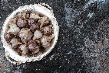 Lot garlic on blue background. Free place.