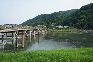 Fototapeta na wymiar Landscape of Togetsu Bridge, Togetsukyo, in Arashiyama, Kyoto prefecture, Japan - 日本 京都 嵐山 渡月橋と桂川 