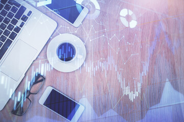 Multi exposure of financial chart hologram over desktop with phone. Top view. Mobile trade platform...