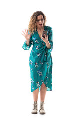 Angry screaming frustrated young woman using cell phone loosing WiFi or reading messages. Full body length isolated on white background.