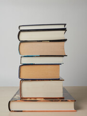 Education learning concept with opening book or textbook in old library, stack piles of literature text academic archive on reading desk and aisle of bookshelves in school study class room background