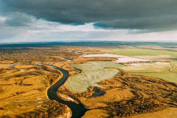 Aerial View Of Dry Grass And Partly Frozen River Landscape In Late Autumn Day. High Attitude View. Marsh Bog. Drone View. Bird's Eye View