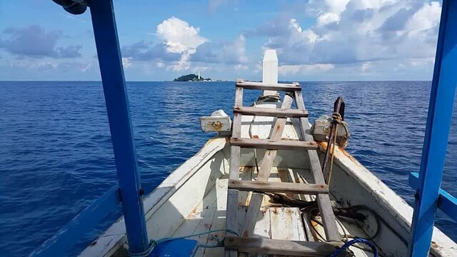 Traveling between small islands on a small wooden motorized boat in Belitung, Indonesia.