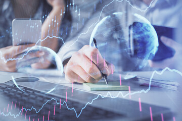Double exposure of man and woman working together and financial graph hologram. Business concept. Computer background.